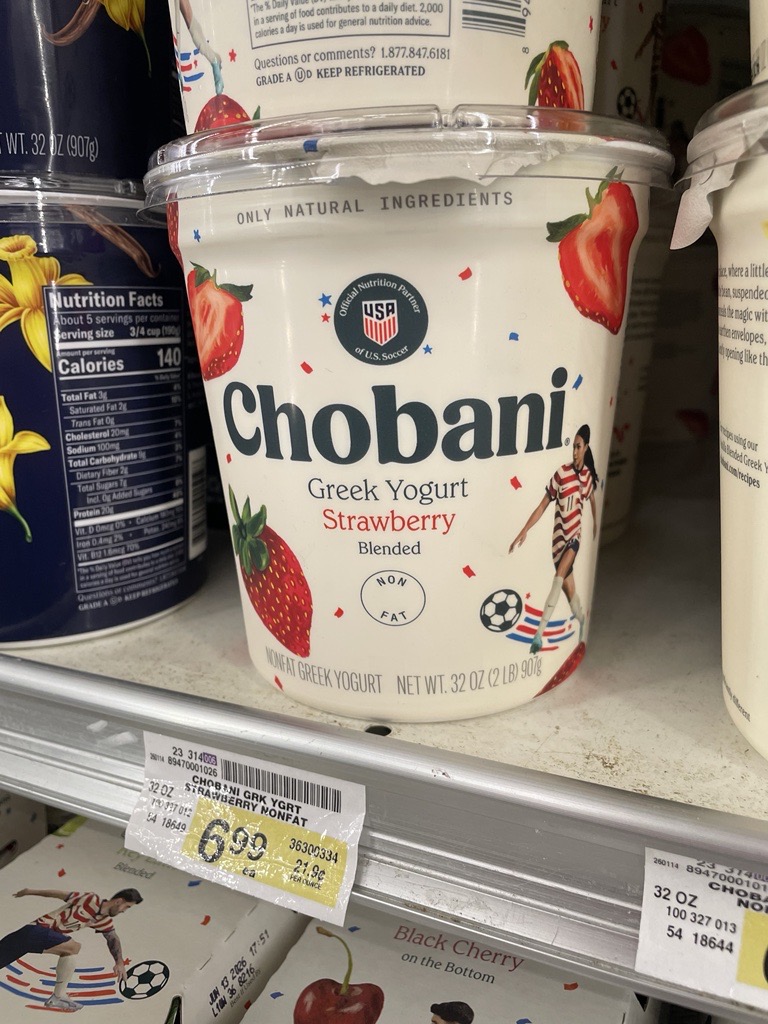 Chobani FIFA Sponsor branded yogurt container on grocery store shelves.